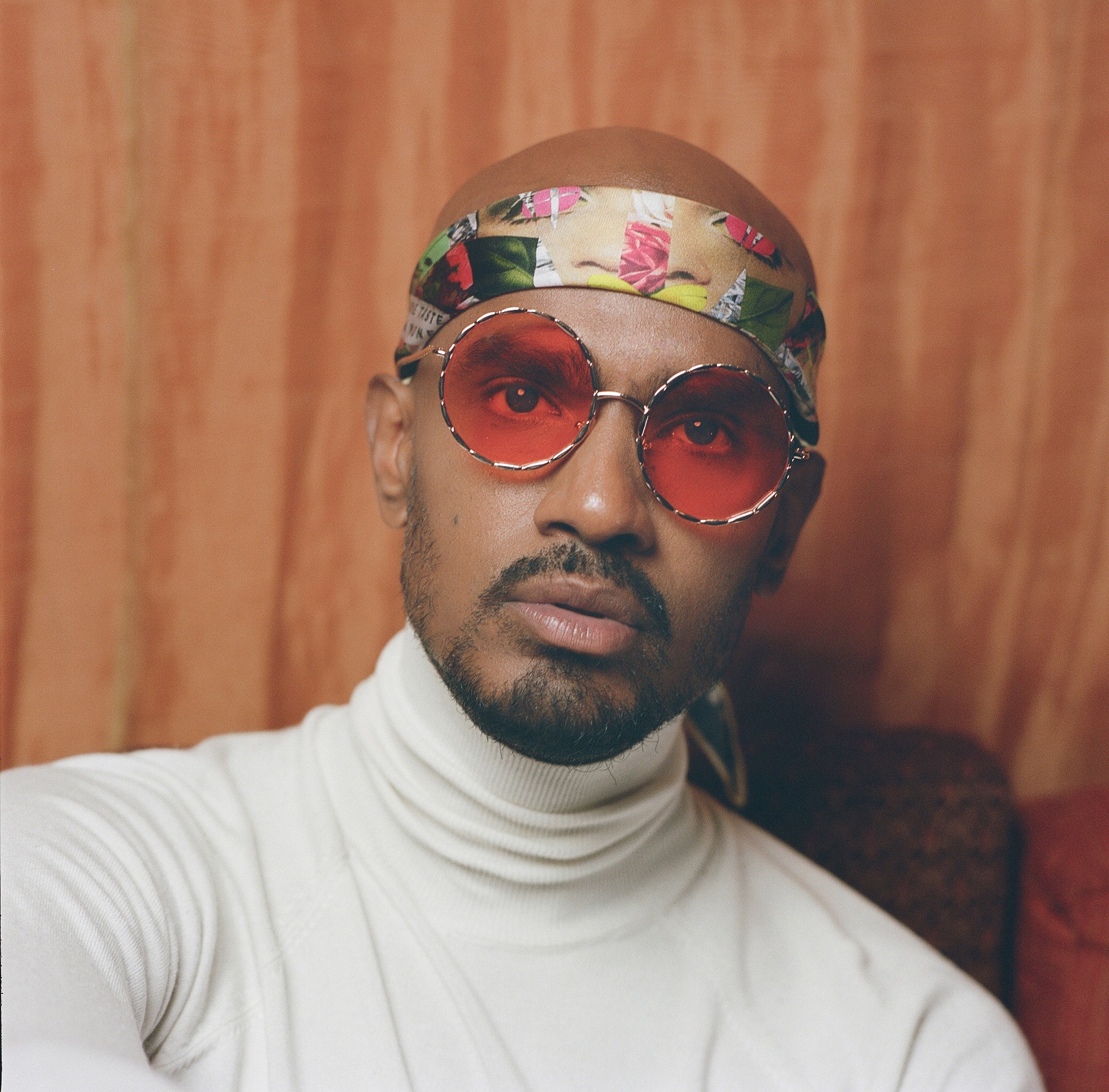 Close-up of a model wearing limited edition Cult Luxury silk scarf, offering exclusive luxury for discerning tastes. Handcrafted artwear in high-quality silk.