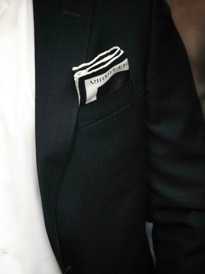 Black Monogram silk pocket square styled in a suit pocket, highlighting Cult Luxury's sophisticated and timeless craftsmanship.