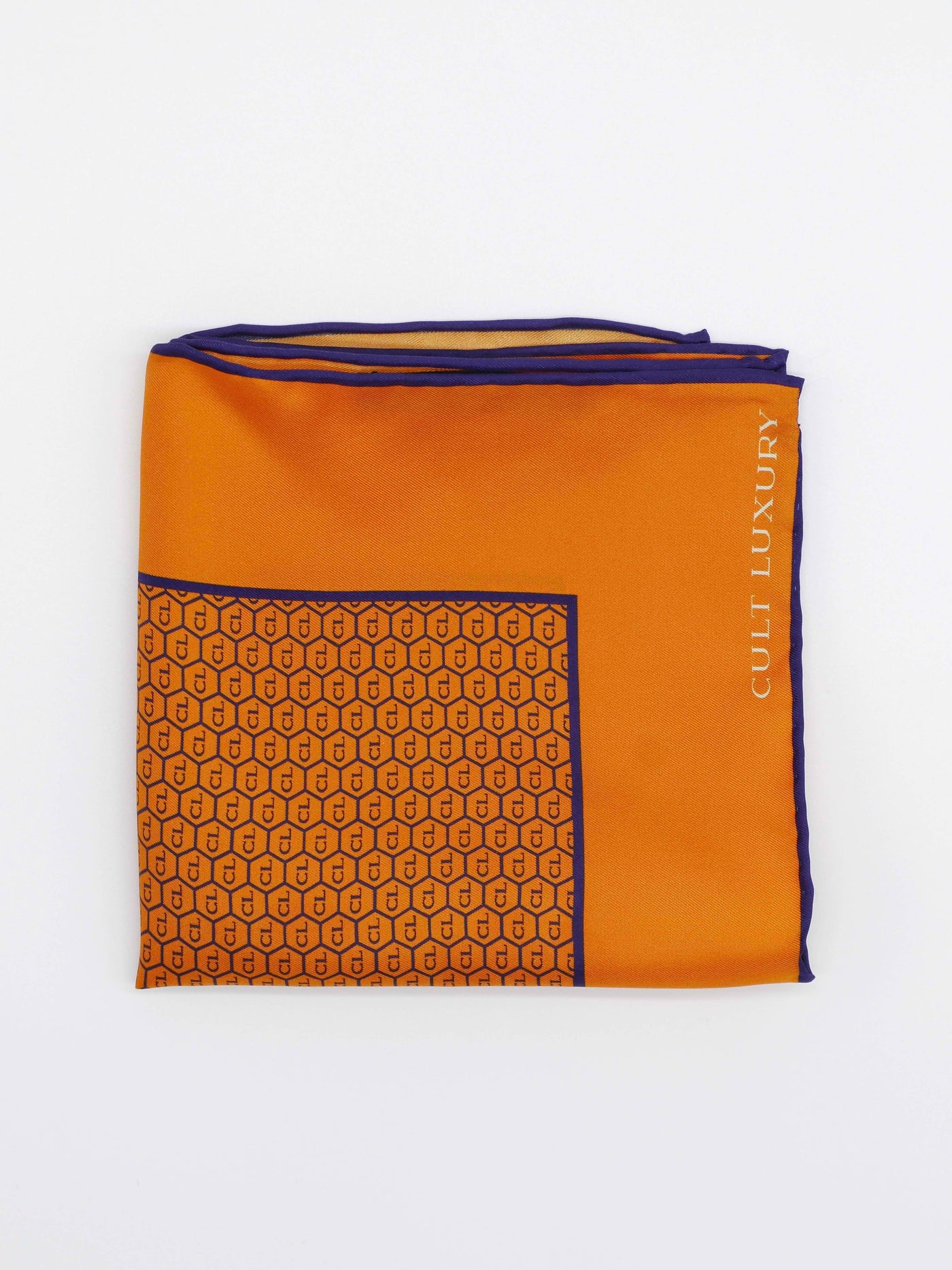 Orange silk pocket square from Cult Luxury, folded flat to showcase the signature monogram print and vibrant hue.