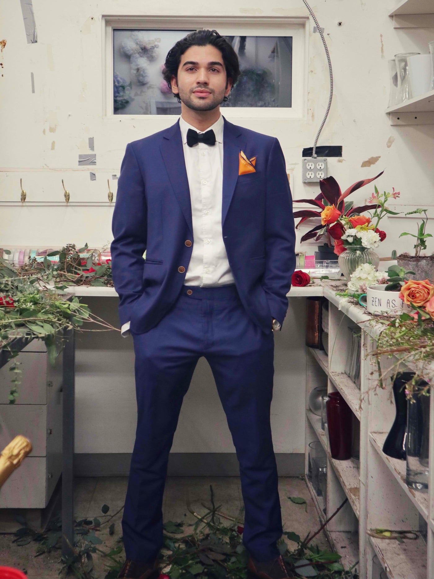 Cult Luxury orange silk pocket square styled in a full blue suit ensemble, combining elegance and modern craftsmanship.