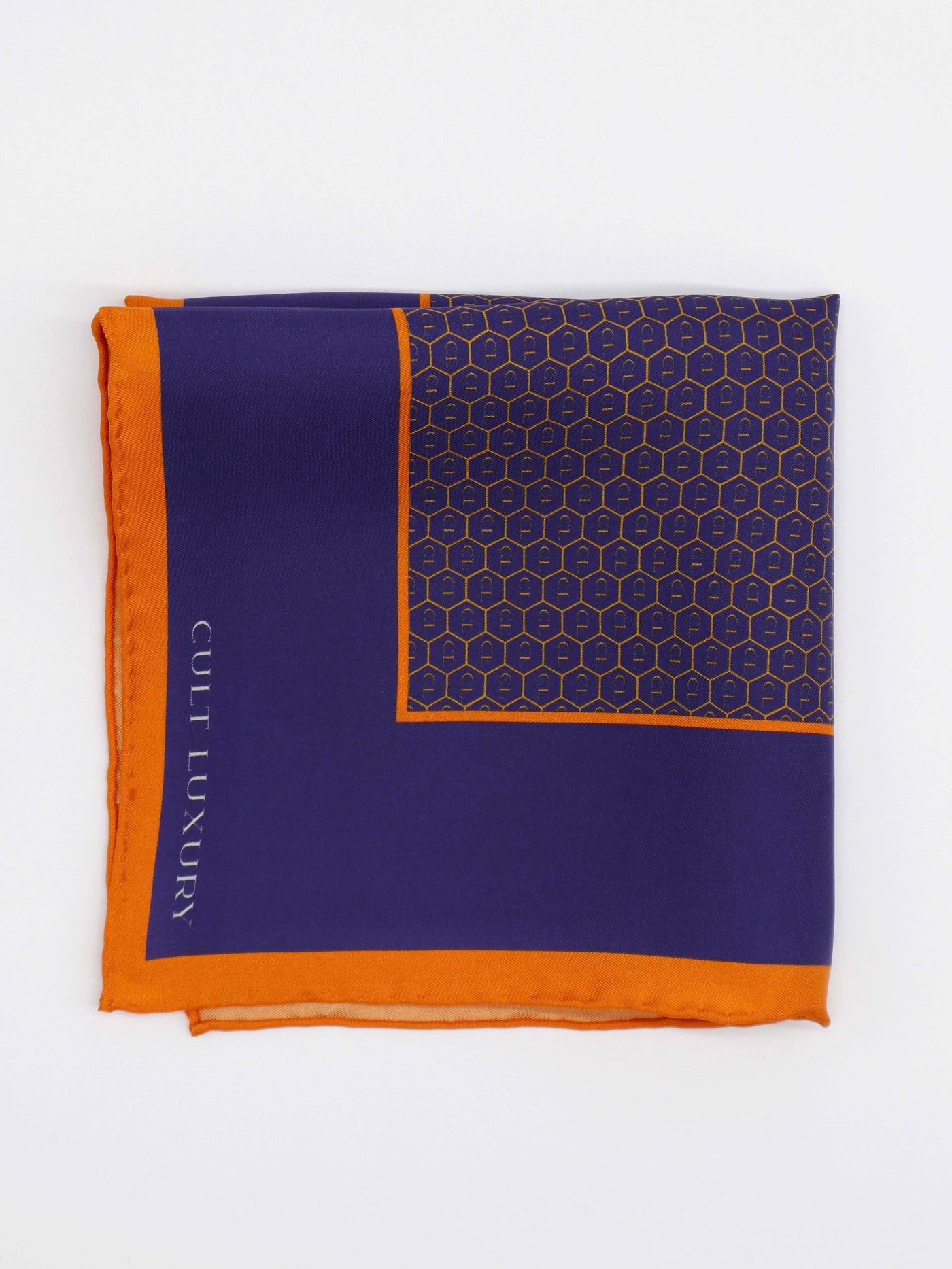 Royal blue silk pocket square from Cult Luxury, folded to showcase its rich blue hue and orange border. A timeless silk accessory designed for refined elegance.