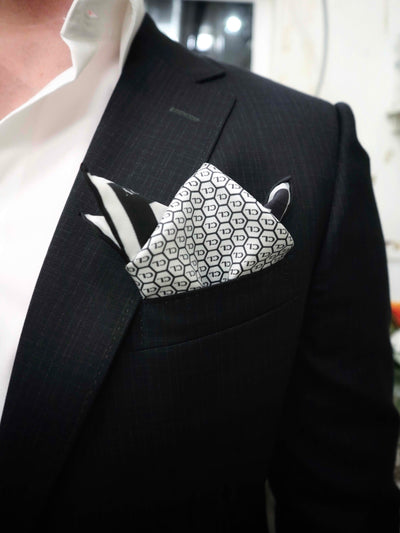 Cult Luxury white silk pocket square styled elegantly in a suit pocket, displaying modern luxury and craftsmanship.
