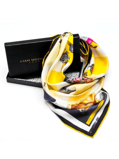 Beloved Armor silk scarf 65 draped with Cult Luxury’s signature black packaging, showcasing the vibrant yellow and black geometric silk design