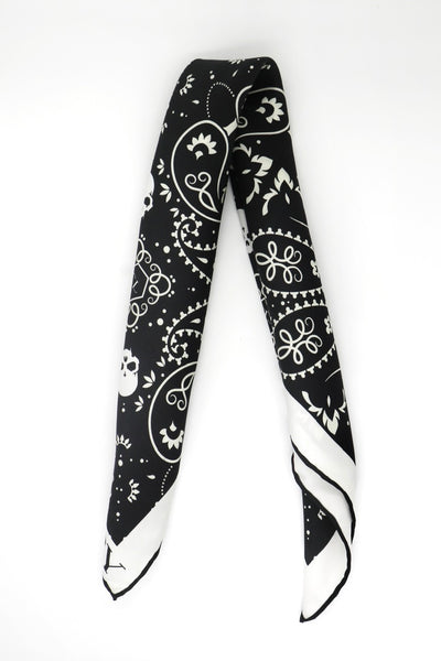 Folded Cult Luxury black silk bandana, showcasing high-quality silk and detailed design.