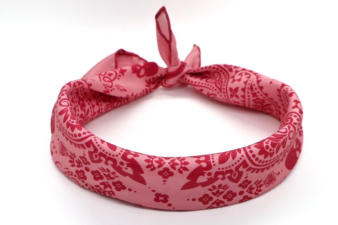 Coral Silk Bandana rolled, displaying luxurious silk texture and intricate detailing by Cult Luxury